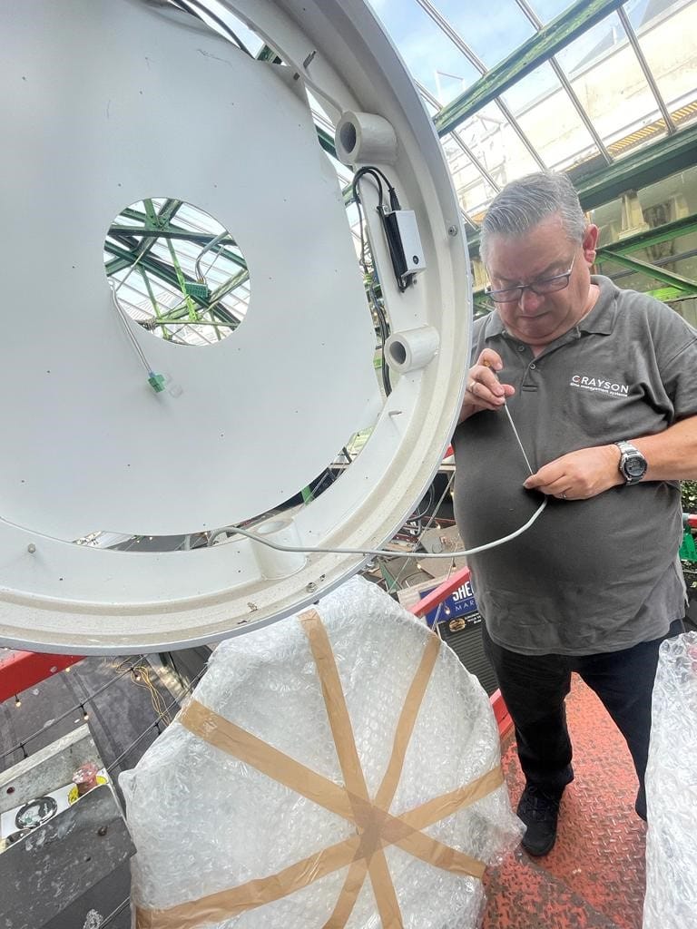 Grayson Engineer checking wiring on the clock